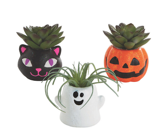 cat, pumpkin, and ghost ceramic planters with plants