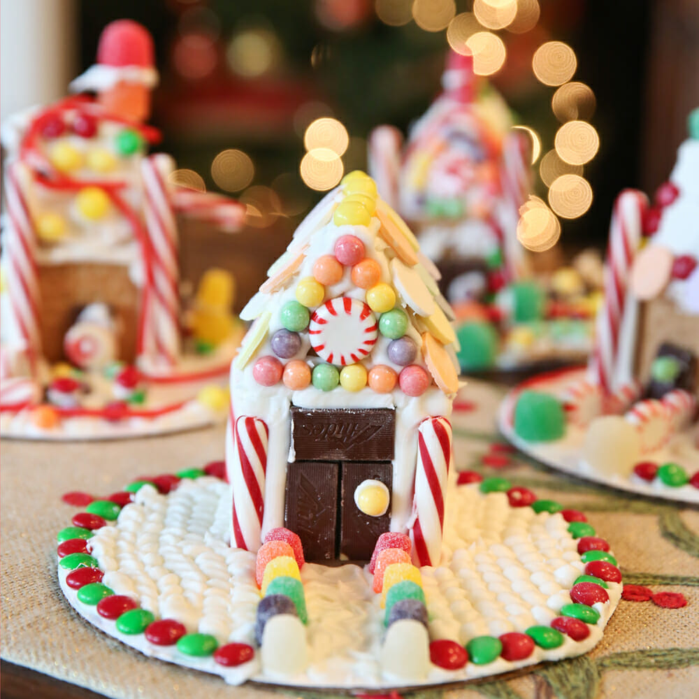 colorful graham cracker houses with icing and candy
