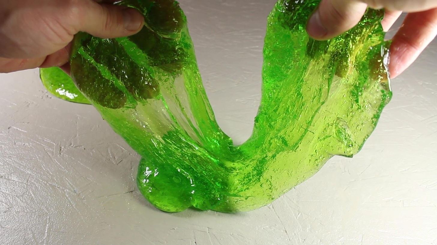 hands playing with green slime