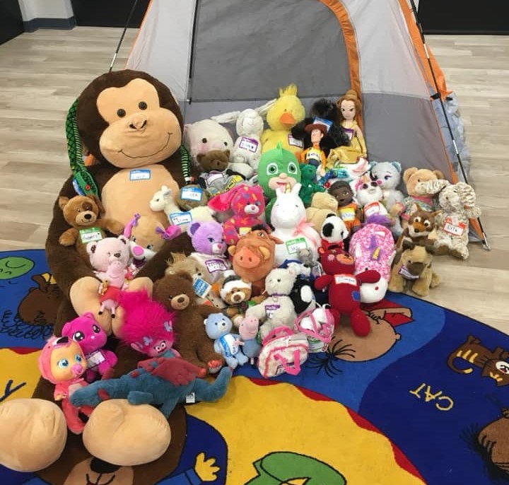 stuffed animals by a camping tent