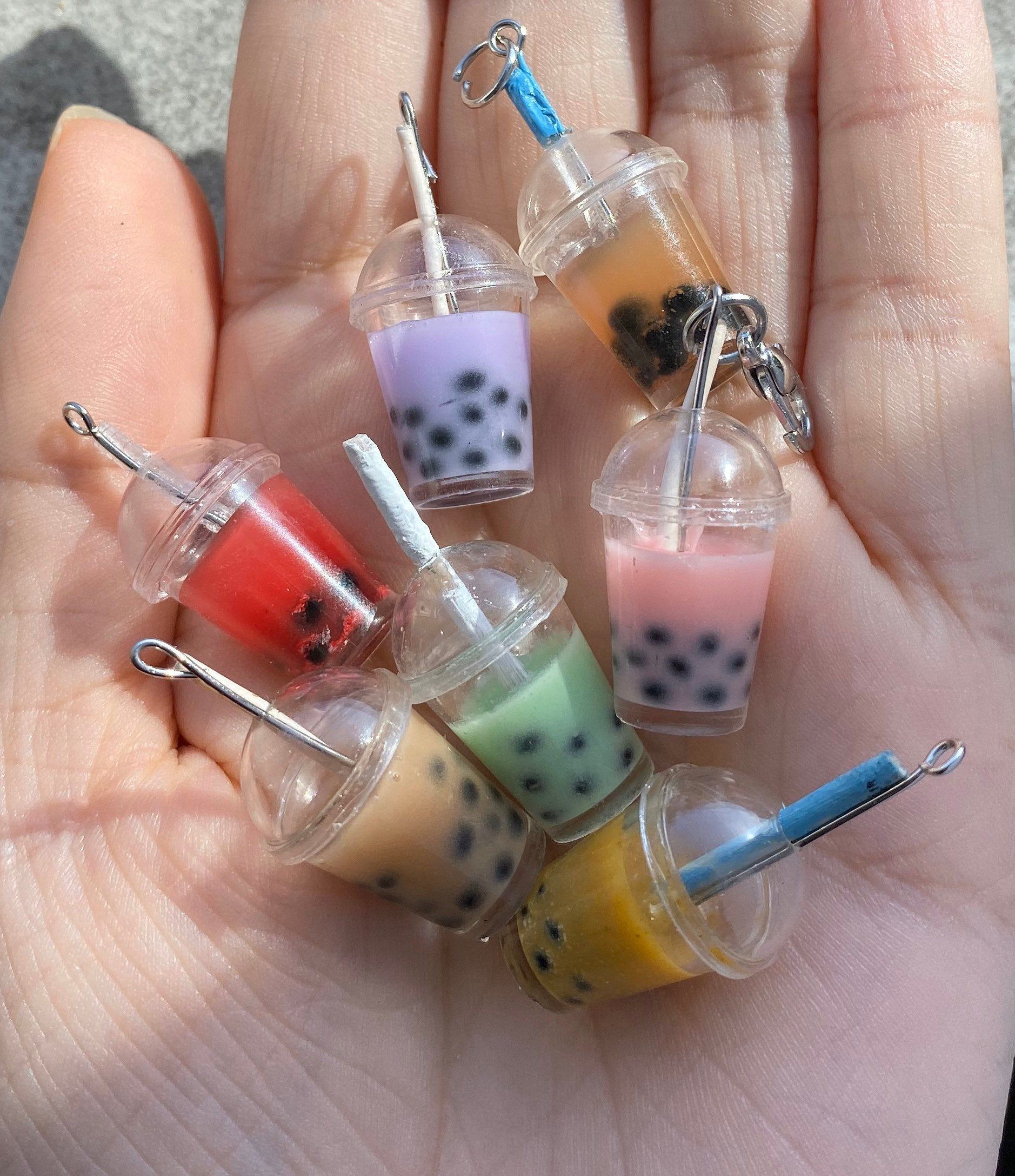 miniature boba keychains in a hand