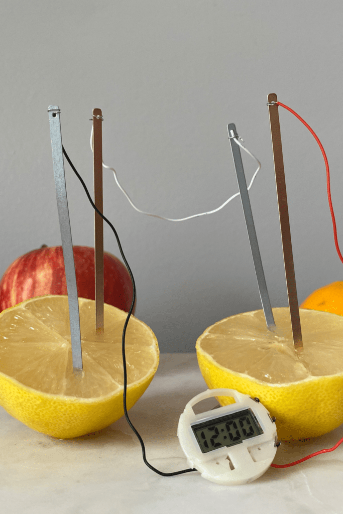 A picture of fruit powering a clock. 
