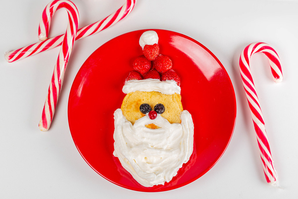 red plate with Santa pancake and candy canes