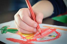 child drawing on a card