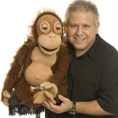 Gene Cordova holding a monkey puppet