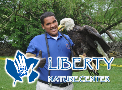 man with bald eagle featuring the Liberty Nature Center logo