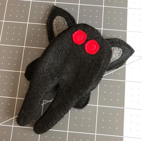 Simple Mothman plush on a cutting mat
