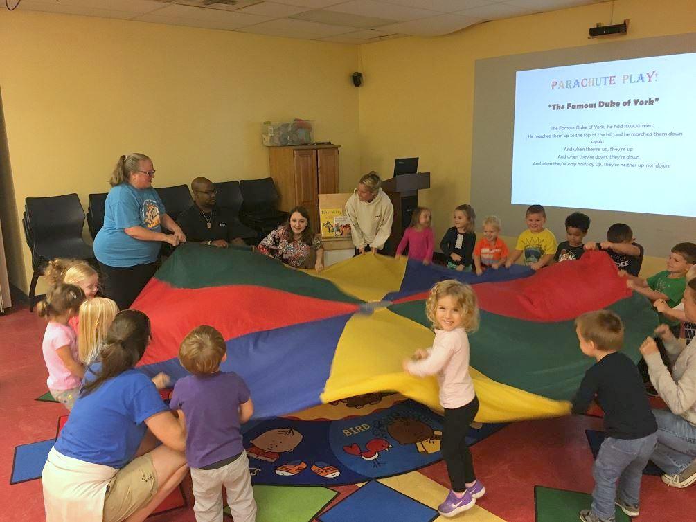 Kids playing Parachute Play during story time