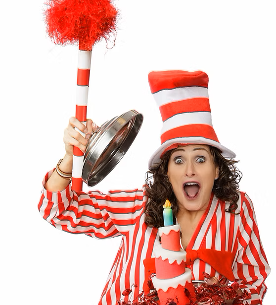 September Cardiff wearing a red and white striped outfit while revealing a pink birthday cake