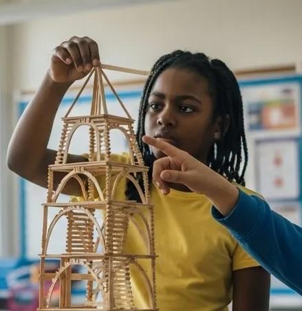 constructing building out of popsicle sticks